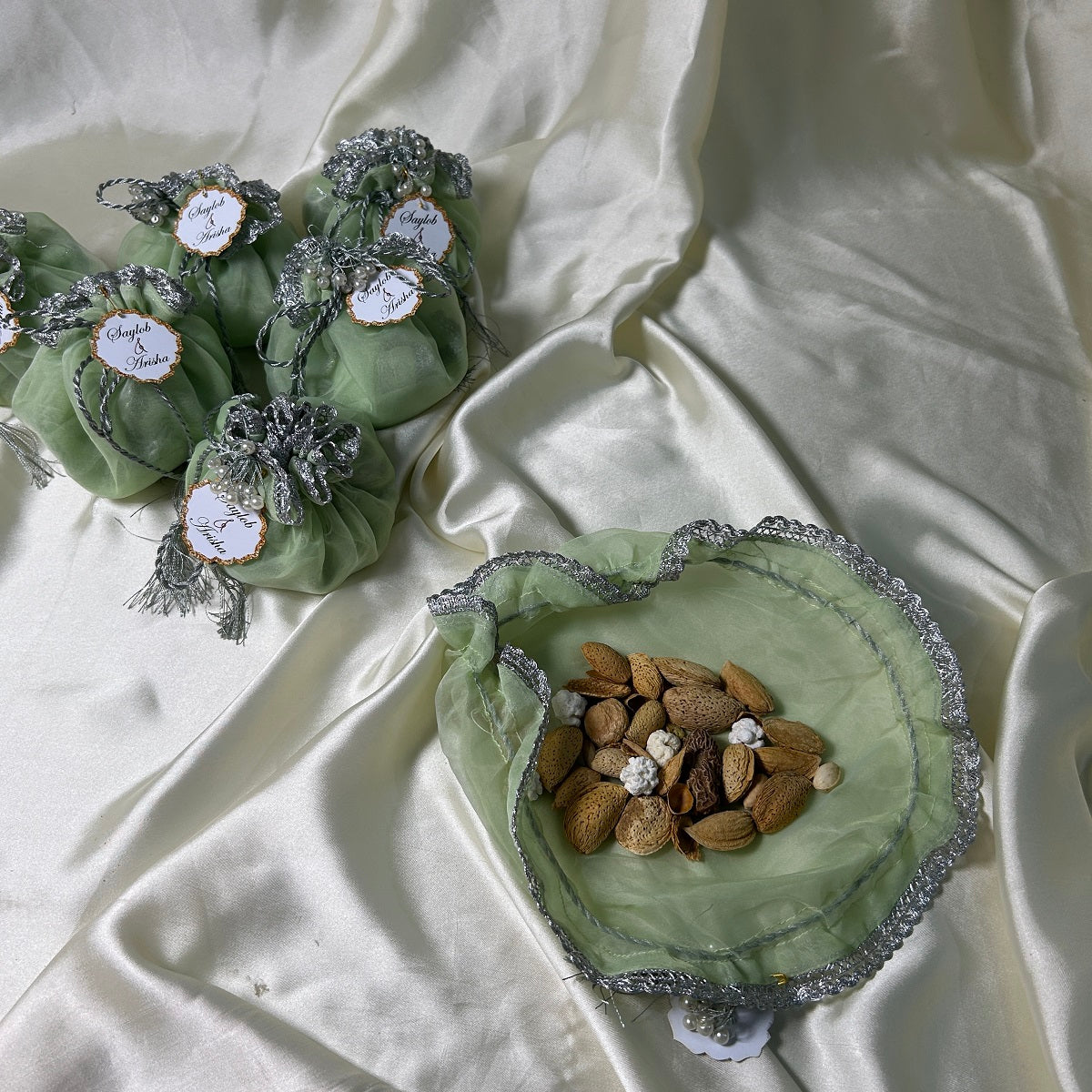 Light green Organza Potlis with Silver String,pearl tassel and name tag