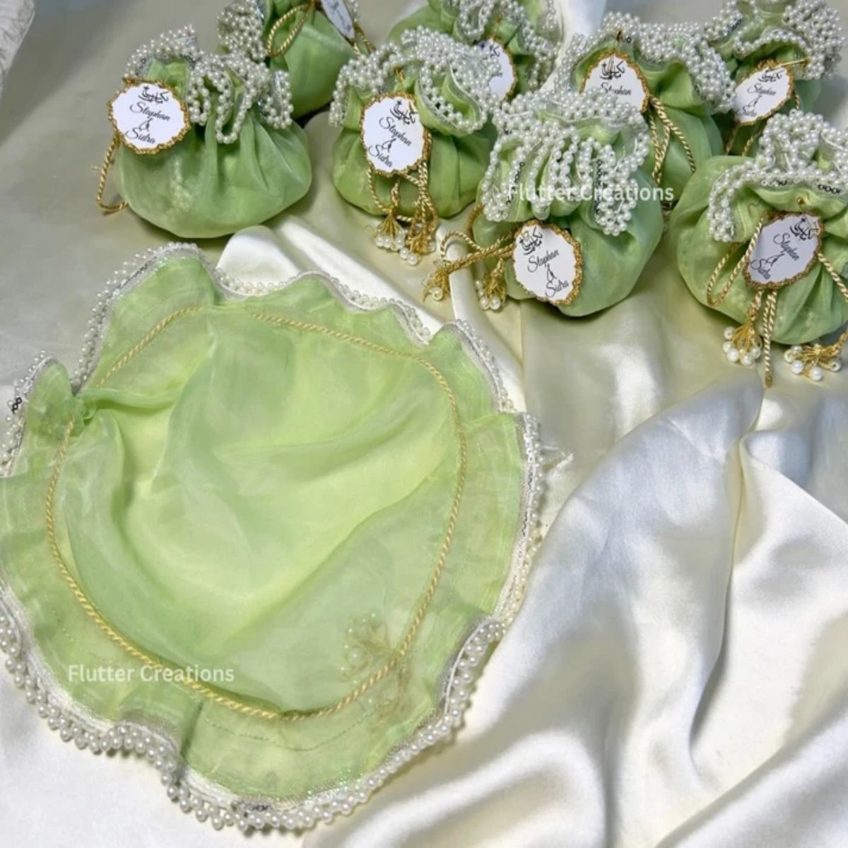 Light Green Organza potlis/pouches with pearl lace and tassel