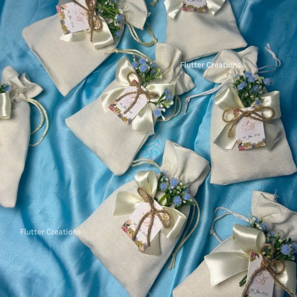 Premium White Pouches/potlis with Blue Baby's breath