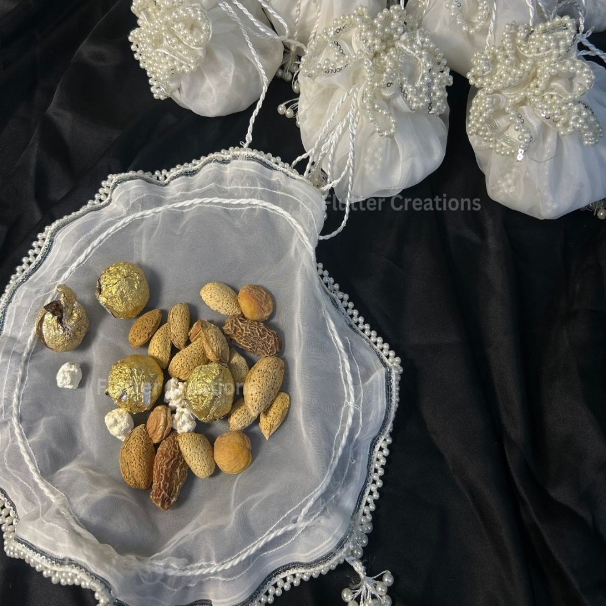 White Organza potlis/pouches with pearl lace