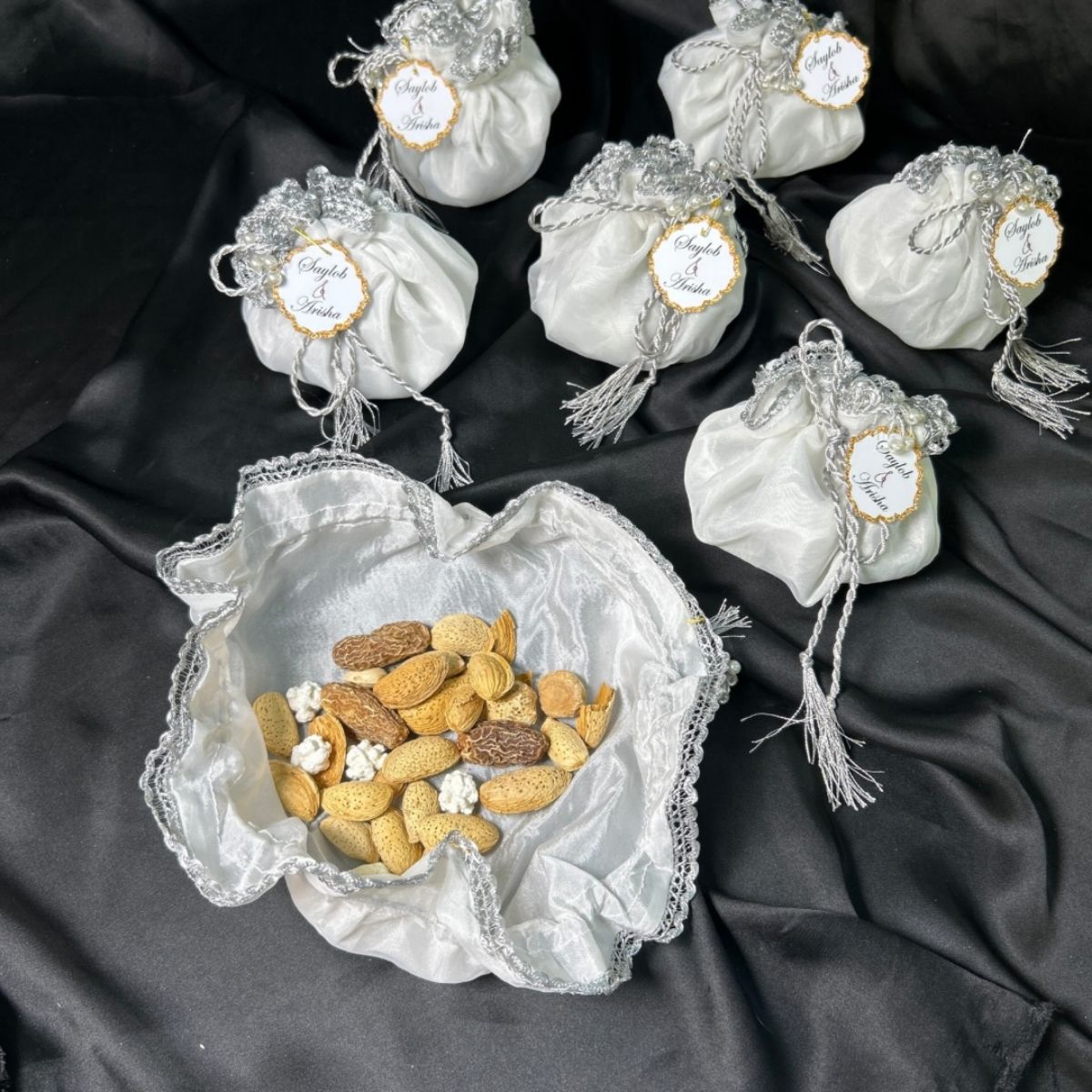 White Organza potlis with silver string ,pearl lace and tassel
