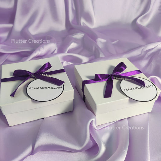 White Box with Blue Ribbon and a Tag