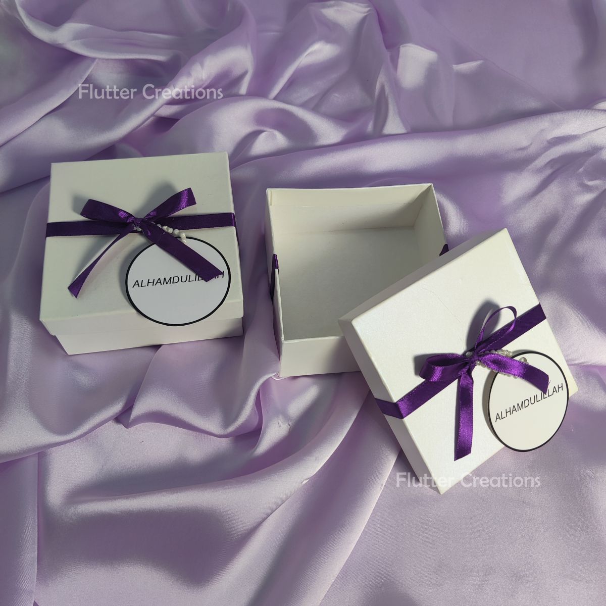 White Box with Blue Ribbon and a Tag