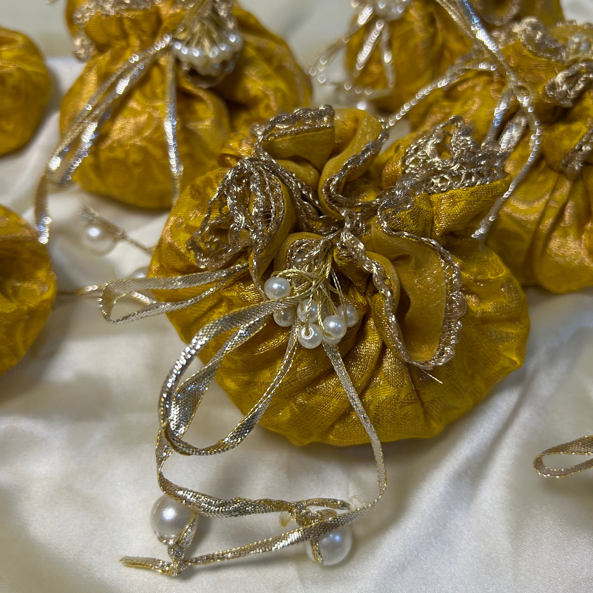Yellow Jamawar potlis bags with pearl tassel