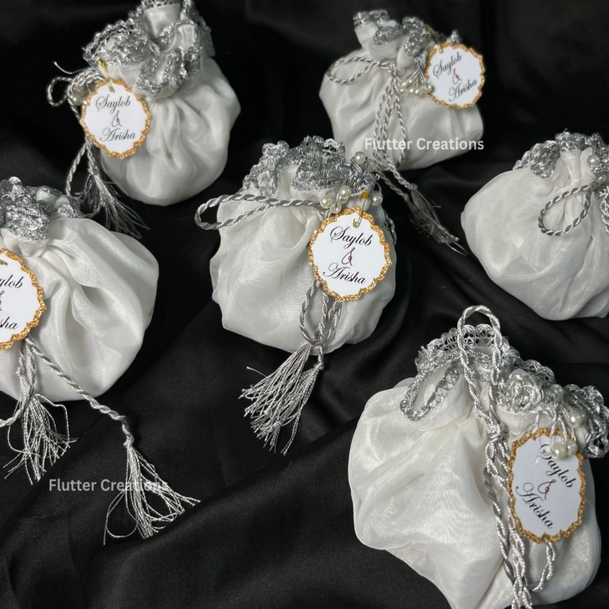 White Organza potlis with silver string ,pearl lace and tassel