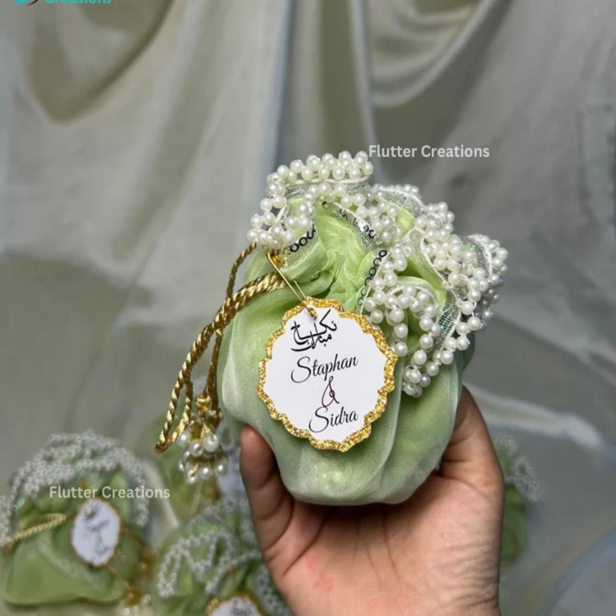 Light Green Organza potlis/pouches with pearl lace and tassel
