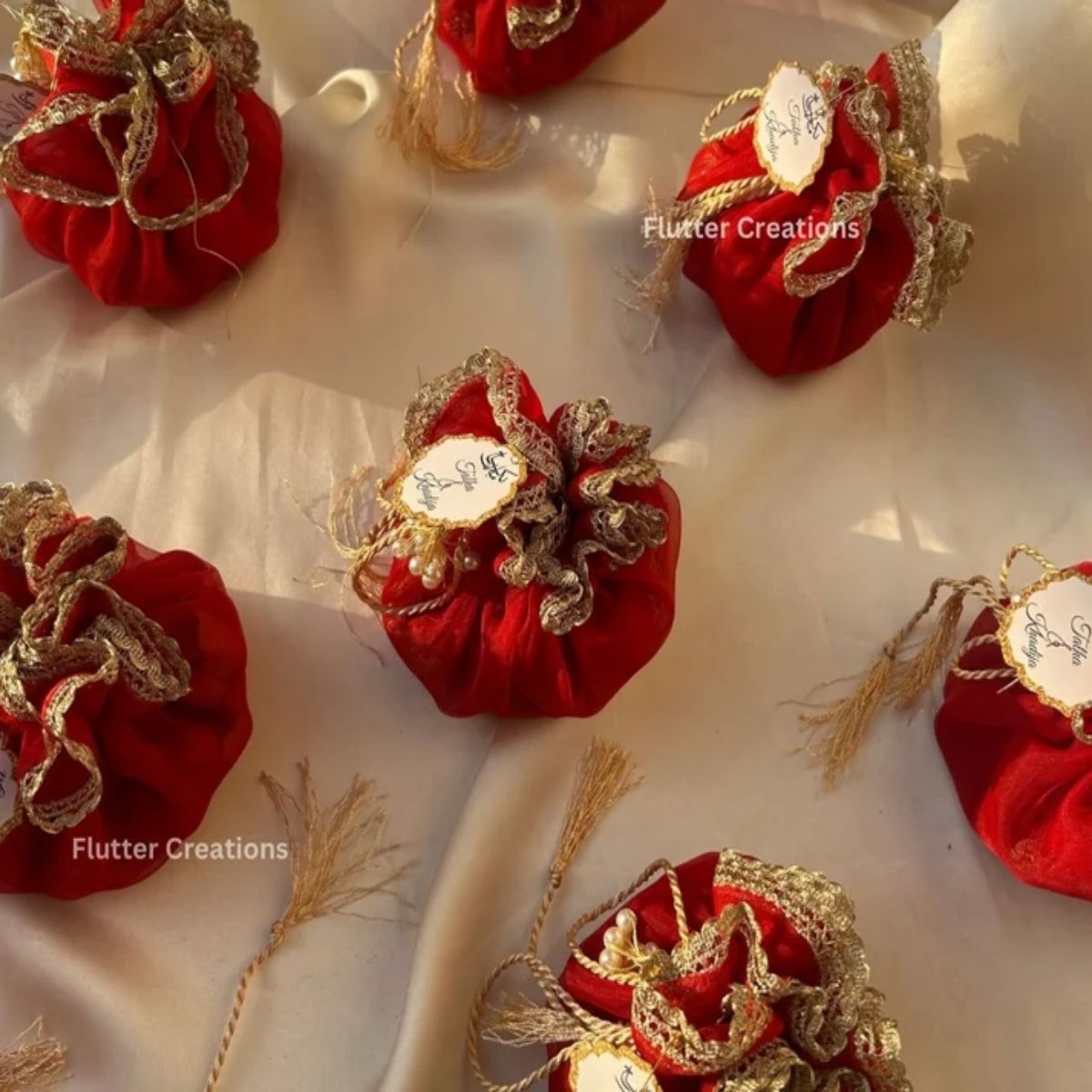 Red Organza potlis with pearl tassel and tag