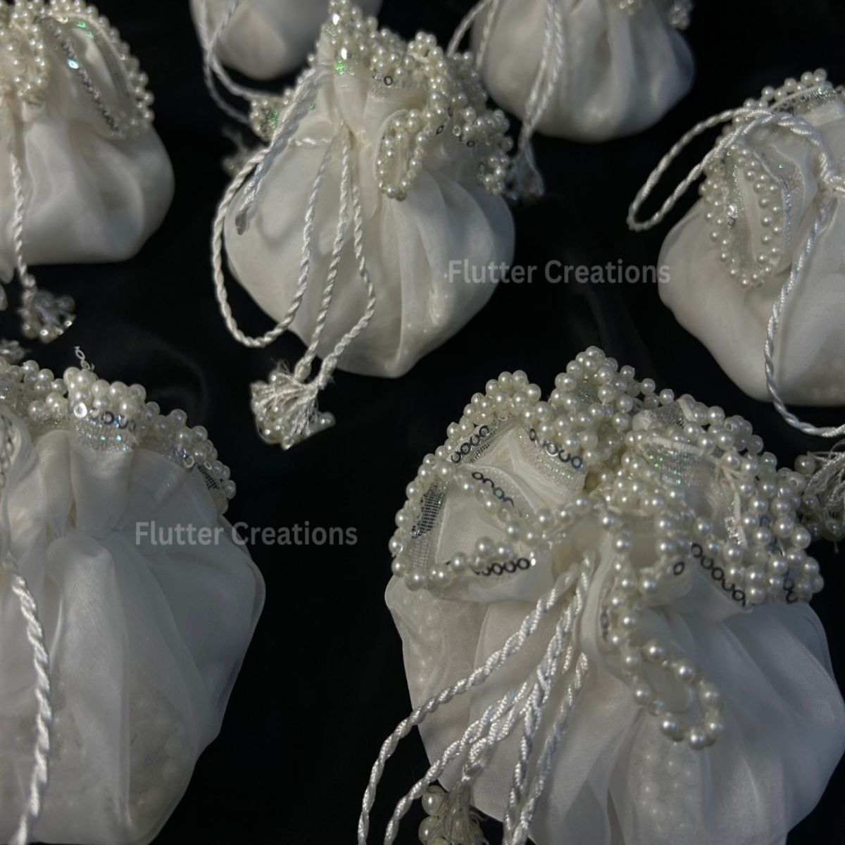 White Organza potlis/pouches with pearl lace