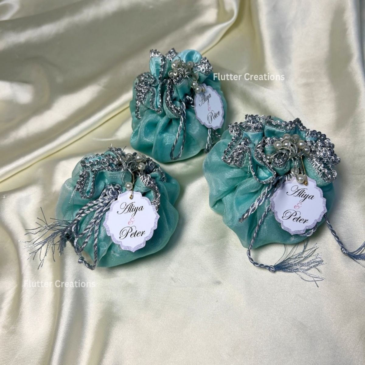 Pink and blue Organza Potlis with Silk lining , pearl tassel and tag